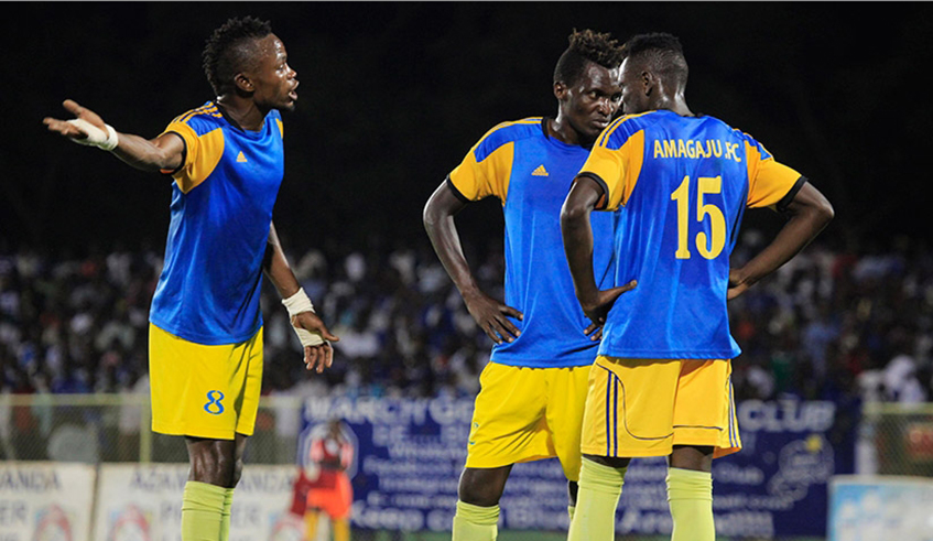 Amagaju FC players discuss during a past match at Kigali stadium. The club will be hoping they can win the return leg against Etoile de lu2019Est and get promotion to the top flight league on Tuesday. / Courtesy.