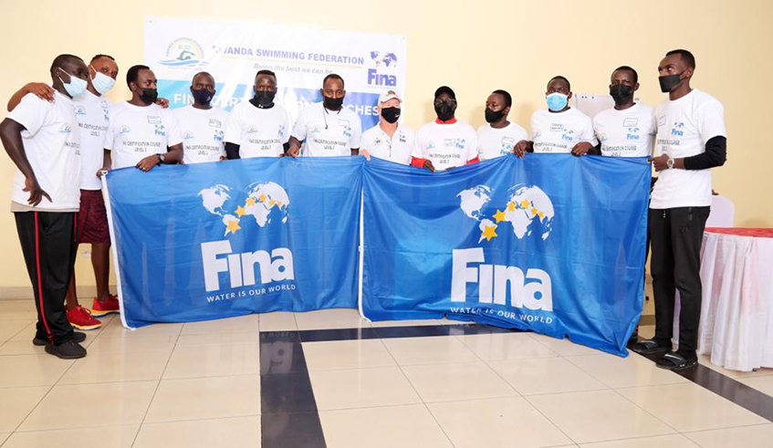 The 10 local swimming coaches who completed a six month training clinic pose for a group photo  after being awarded certificates. Photo: Courtesy.