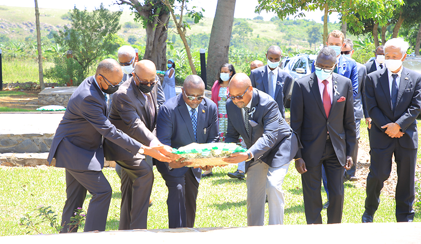 Rwanda's High Commissioner to Uganda Joseph Rutabana, and other Diplomats accredited to Uganda, lay a wreath on mass graves of victims of the 1994 Genocide against the Tutsi yesterday at Golo memorial Centre, Mpigi (Saturday) yesterday.