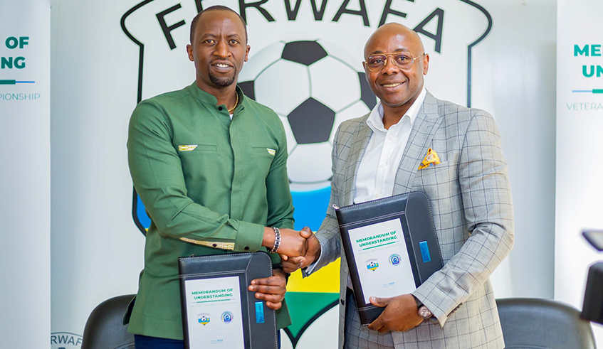 Ferwafa boss Olivier Nizeyimana (L) and the head of FIFVE  Fred Siewe after signing the memorandum of understanding to collaborate in organising the veterans world cup. Courtesy